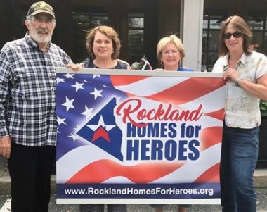 Harley Davidson hangs Rockland Homes for Heroes banner